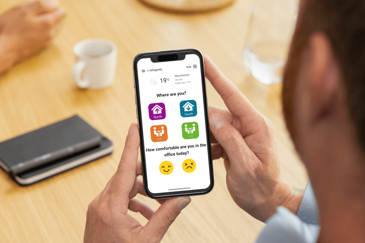 Person using Entelligently on a smartphone to provide workplace comfort feedback.